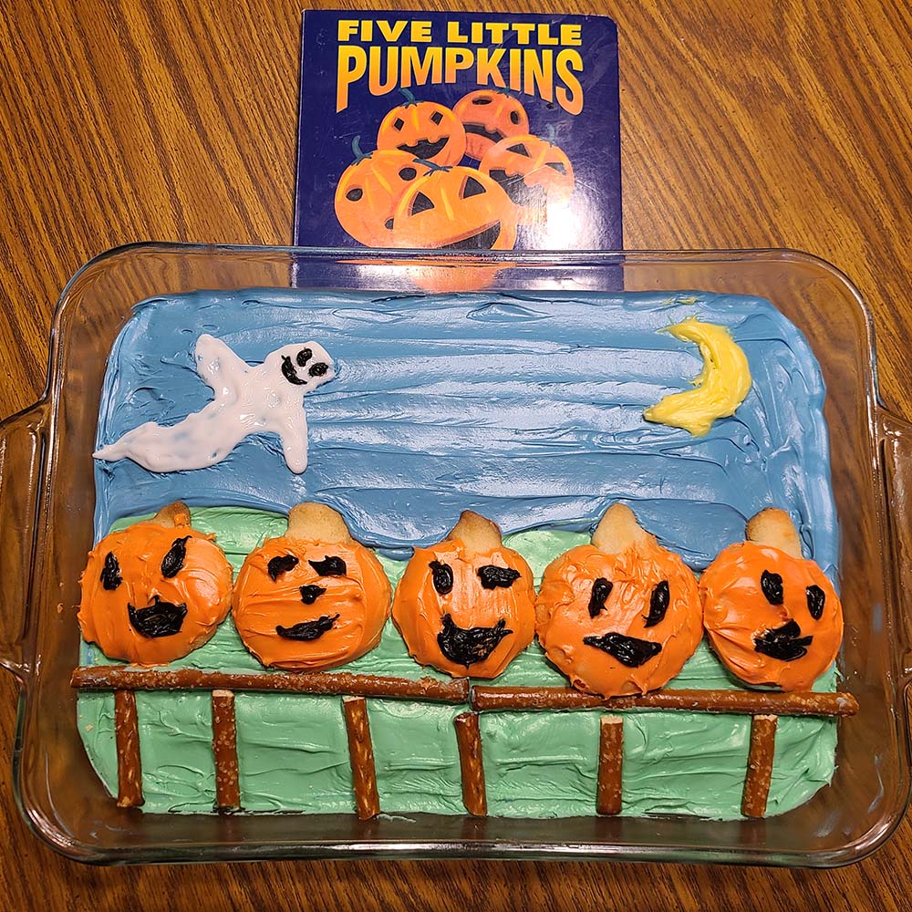 We used sugar cookies with icing for the pumpkins. The scene was made from confetti cake with icing with food coloring. The fence is made from pretzel rods. 