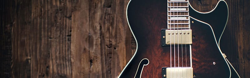 a guitar against a wood background