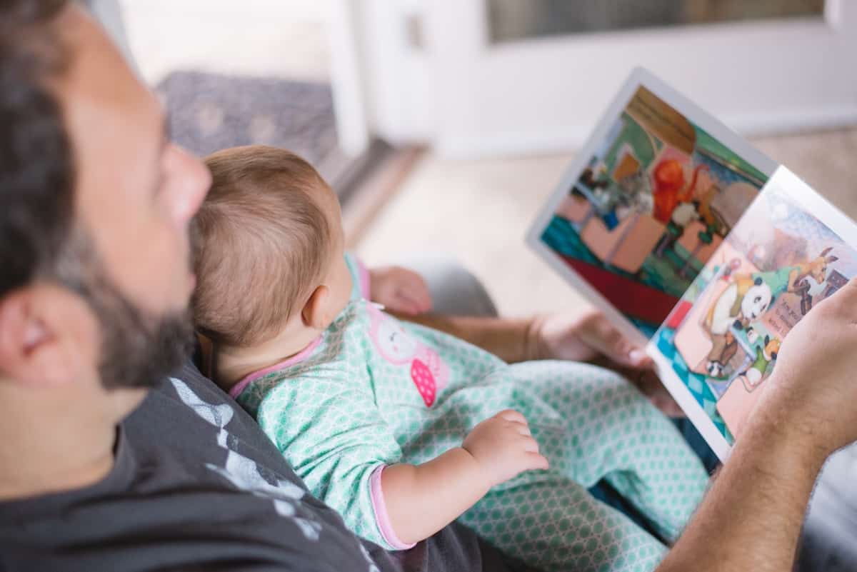 Dad Reading To Baby