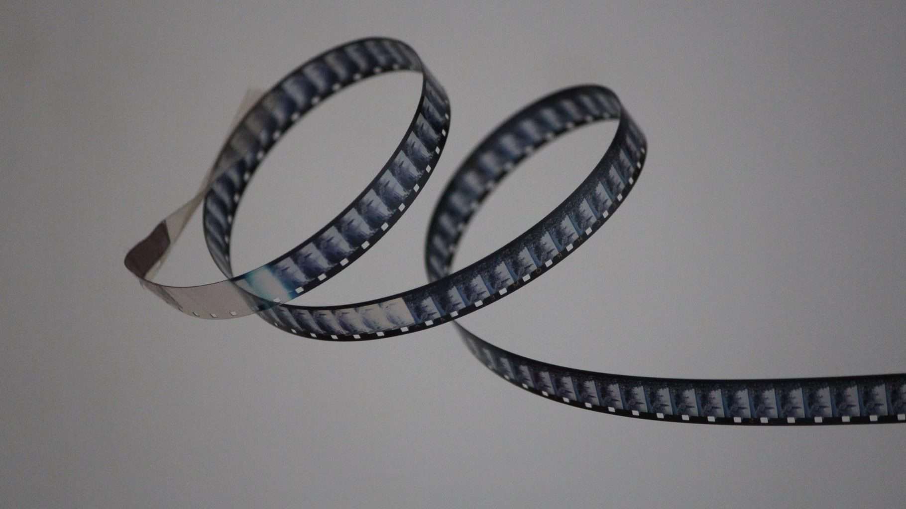 a filmstrip curling artfully on an empty background