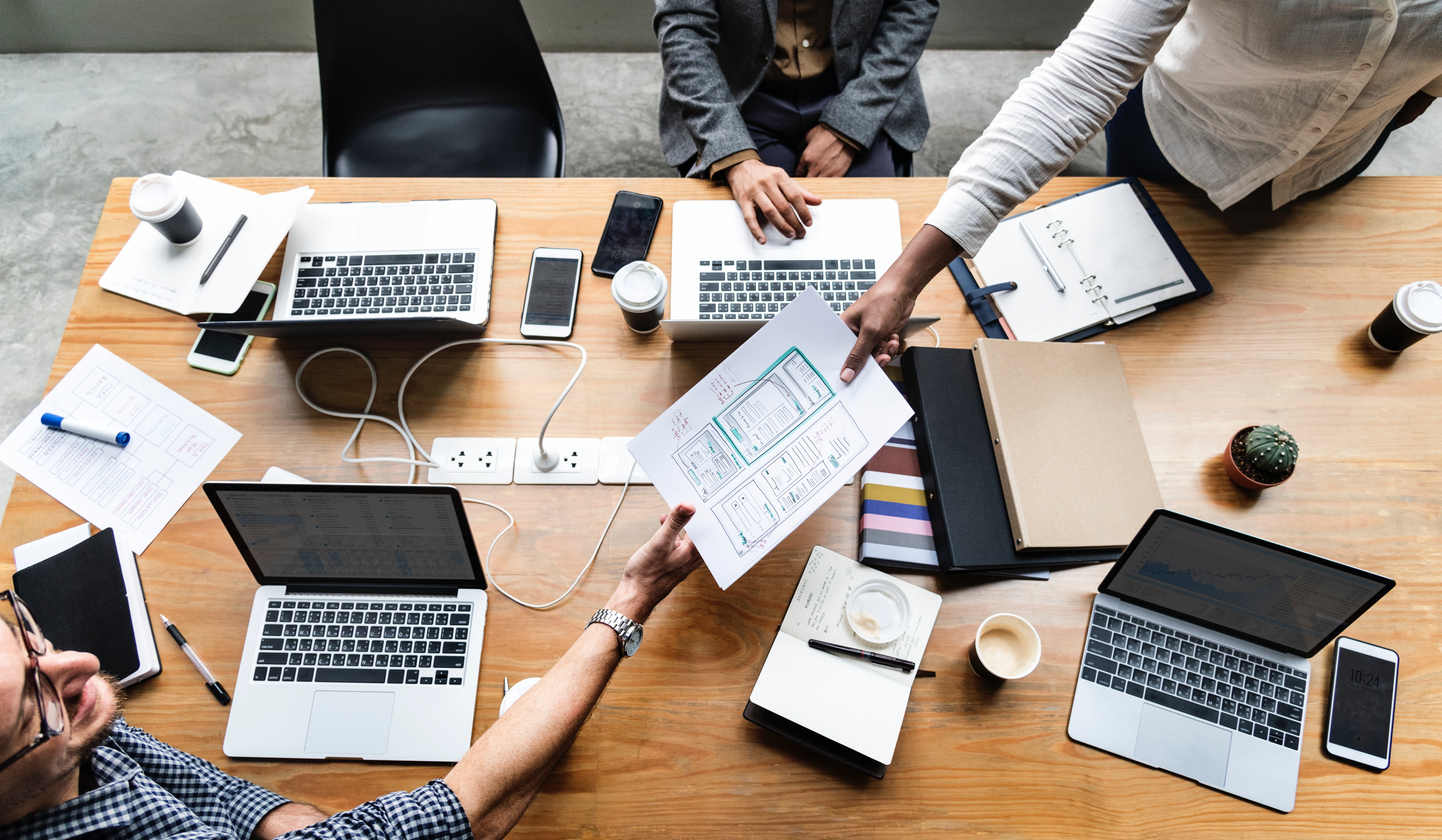 a group of people working around a table