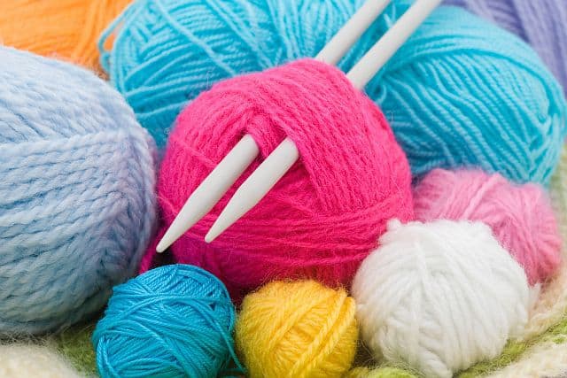 Knitting needles with balls of yarn