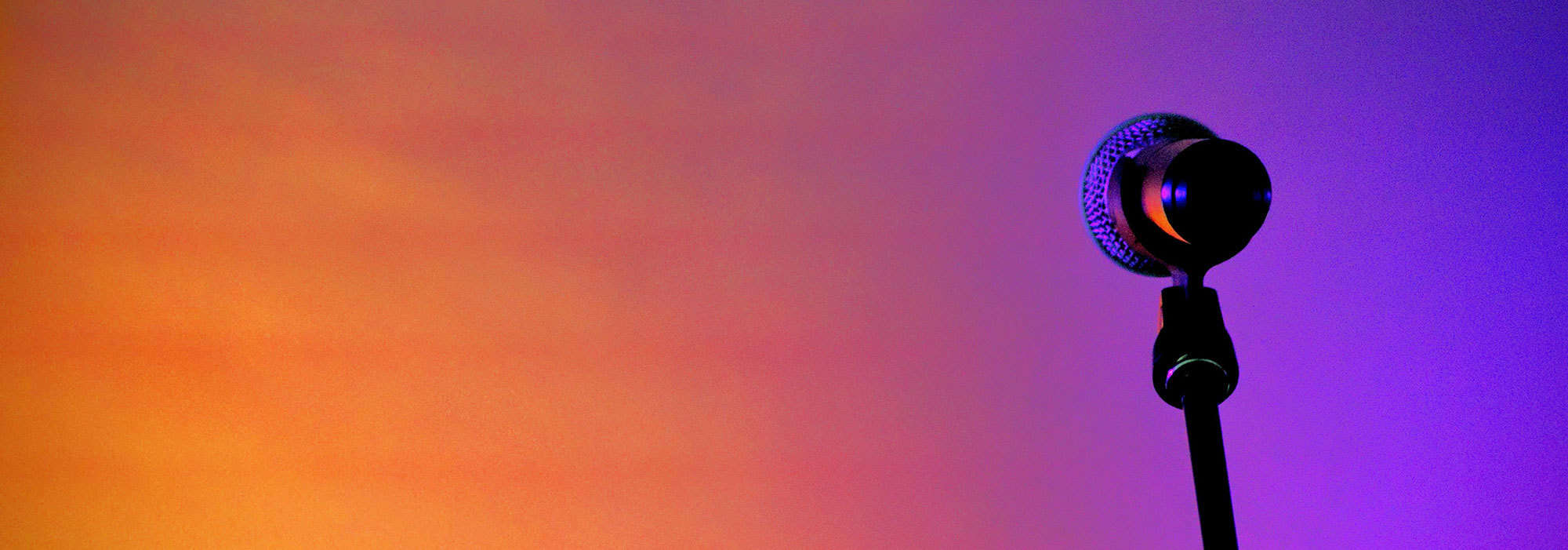 a microphone against an orange and purple background