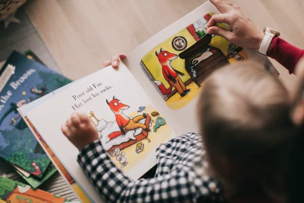 Child reading with adult