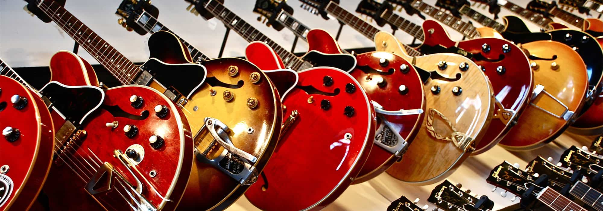 gibson guitars displayed on a wall