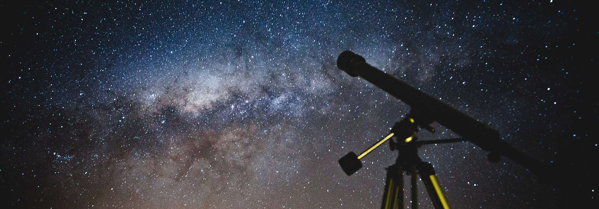 a telescope set against the night sky