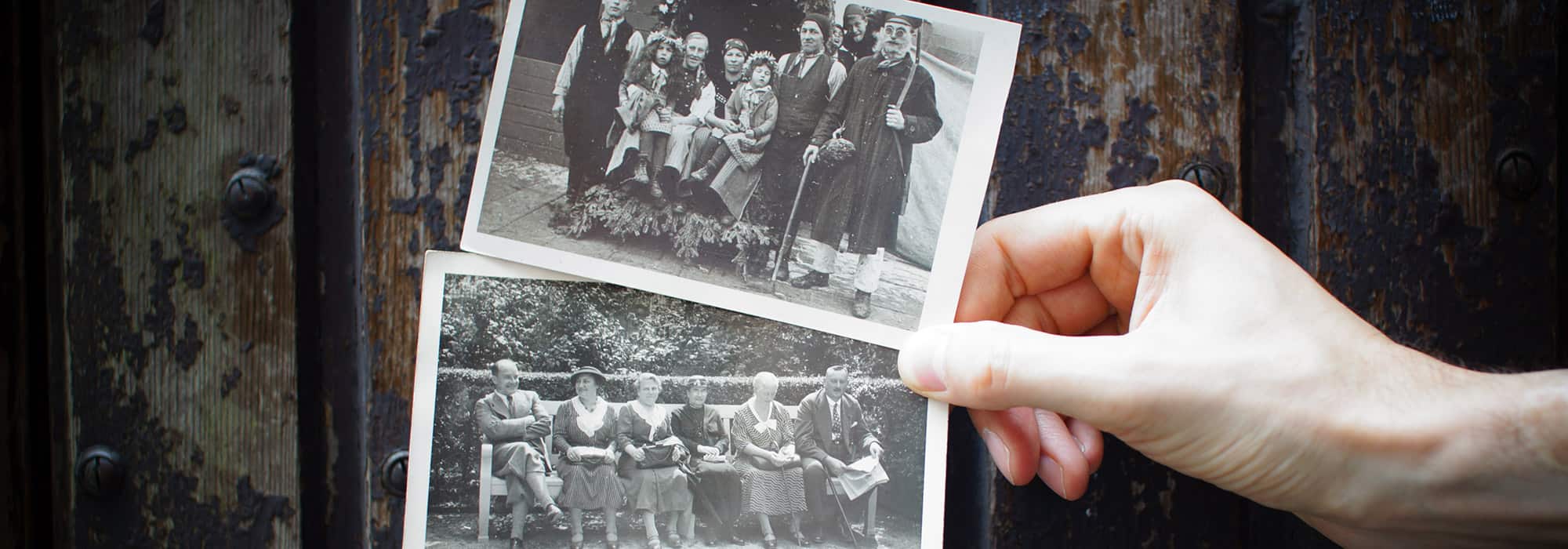 a hand holding old family photos