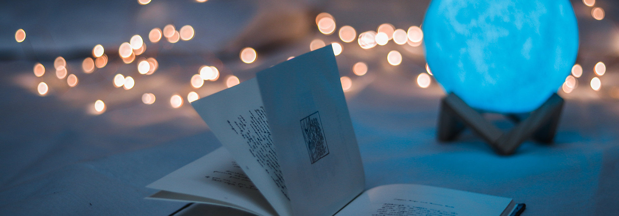an open book and a glass orb