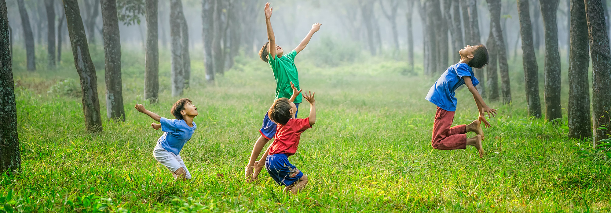 kids jumping in a field
