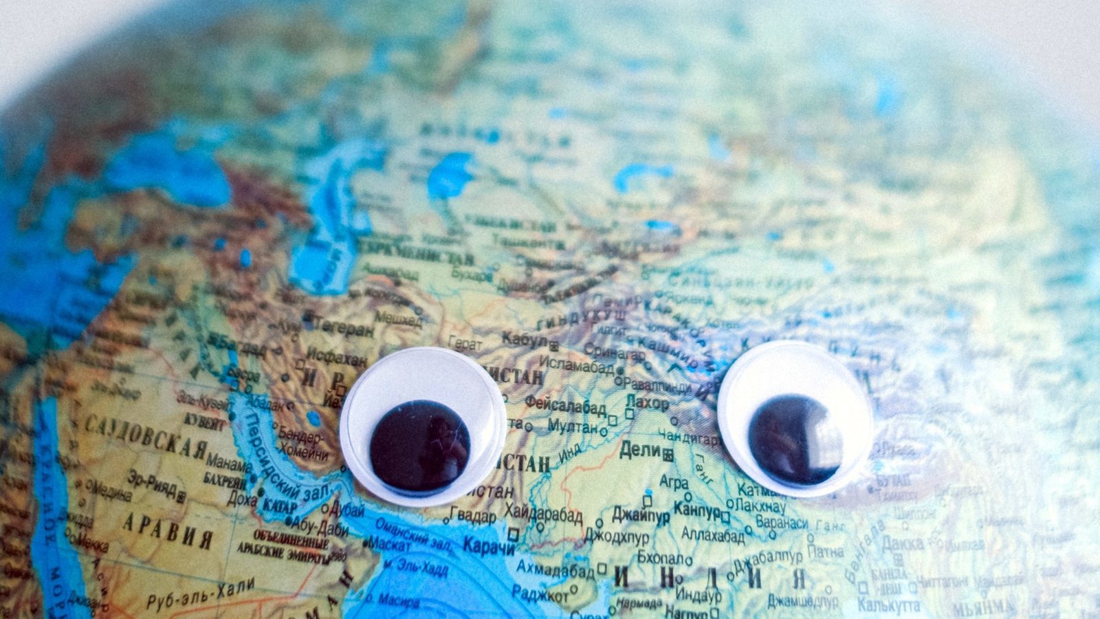a globe with googly eyes