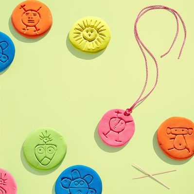 colorful clay necklaces with taino petroglyph designs
