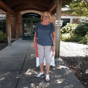 A woman, Barbara Soden, standing in front of the Maumelle Library branch