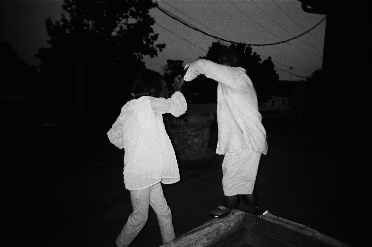 Two people in white clothes dancing