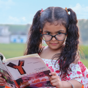 girl in glasses reading book