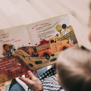 baby and parent reading book