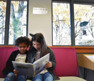 Kids sitting in birdwatching area with book